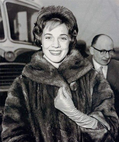 A Woman Wearing A Fur Coat And Gloves