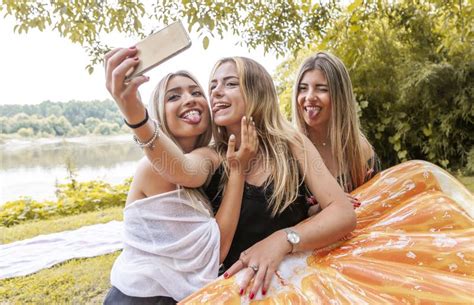 Female Millennial Girlfriends Taking A Selfie Outdoors On The River Stock Image Image Of