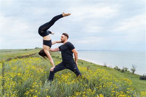 Couple Practicing Acro Yoga Poses Outdoors Outside Pair Of Sportsmen