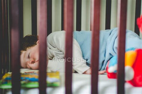 Boy Sleeping In Crib — Lifestyle Wooden Stock Photo 138227970