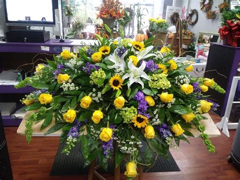 We offer same day delivery from the best florist in slidell! yellow, purple and white casket spray Krazy Daisy Flowers ...