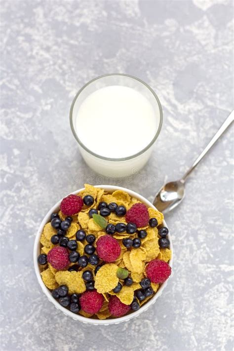 Healthy Tasty Breakfast Bowl With Corn Flakes And Berries And Glass Of