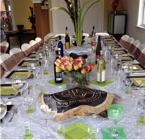 A Long Table With Wine Bottles And Glasses On It Is Set Up For A Formal