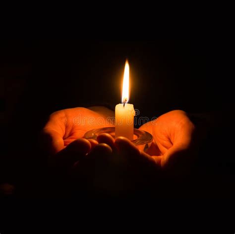 Hands Holding A Burning Candle In Dark Room Stock Photo Image Of