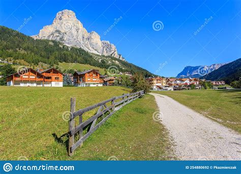 Path In Traditional Alpine Village With Dolomites Mountains In The