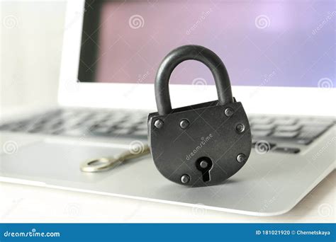Vintage Metal Lock With Key And Laptop On Table Protection From Cyber