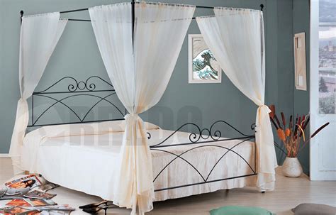 The headboard and footboard with impressive curves are well complemented by the four posts with round finials, adding to the aesthetic appeal of this canopy metal princess bed. Wrought iron canopy bed SABRINA Ales iron color Graphite black