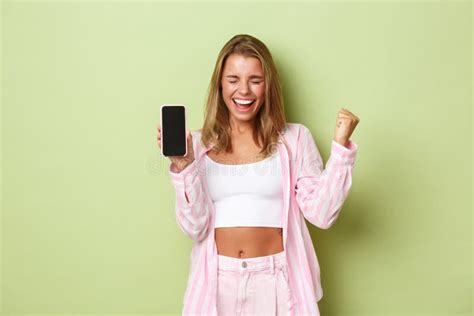 Image Of Excited Blond Girl Winning Something Showing App Achievement