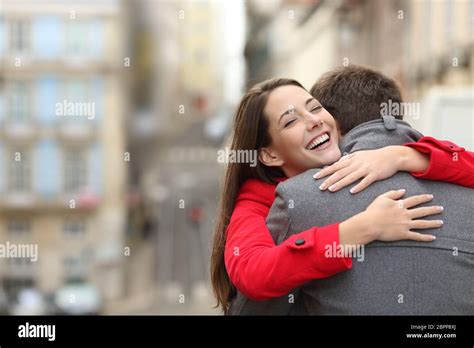 Cheerful Couple Meeting And Hugging In The Street With Copy Space At