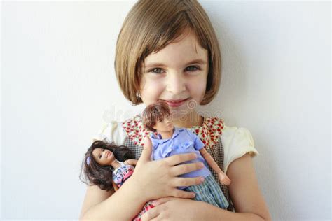 Little Girl Holding Boy And Girl Dolls Royalty Free Stock Photo Image