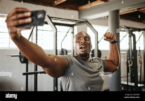 Gym Selfie Smartphone And Man Flexing Arm Muscle For A Post Gyming