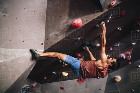Athletic Man Bouldering At An Indoor Climbing Centre Professional
