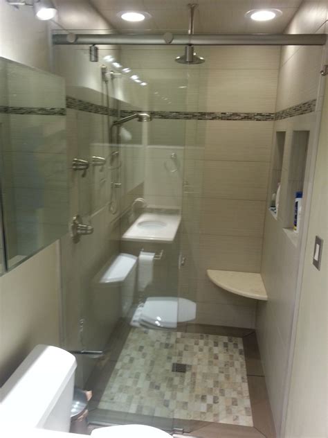 High comfort level in the bathroom. Small bathroom with inset tile floor, curbless shower ...