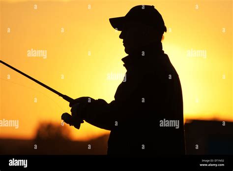 Fisherman Silhouette At Sunset Stock Photo Alamy