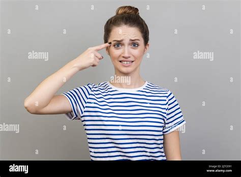 Crazy Idea Portrait Of Woman Wearing Striped T Shirt Showing Stupid Gesture Looking With