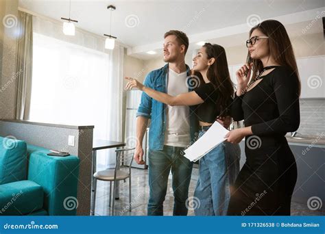 Attractive Woman Realtor Property Sales Manager Showing New Appartment On Sale To Young