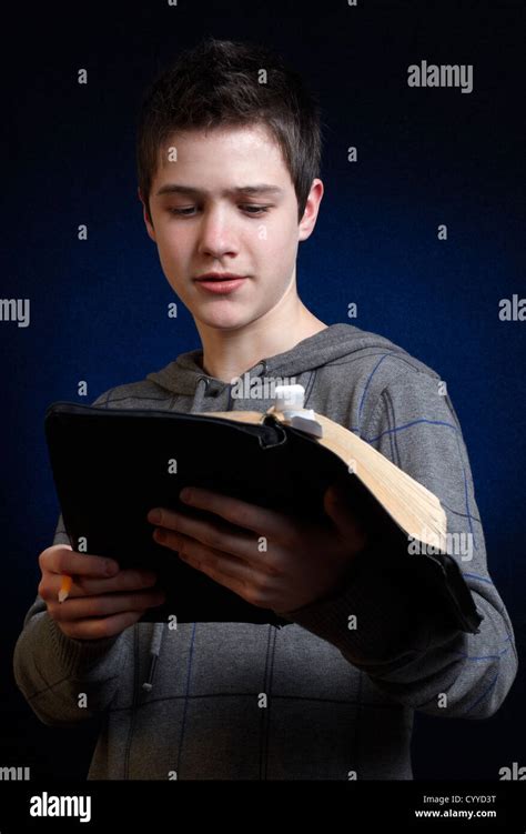 Young Man Reading And Studying In His Bible Stock Photo Alamy