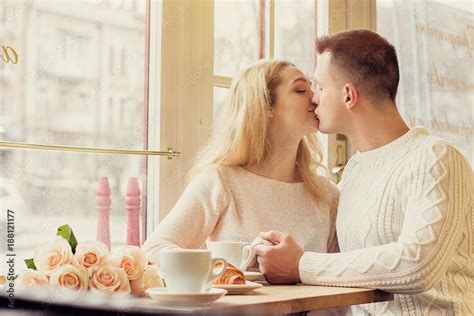 Young Couple Having Romantic Dinner In Cozy French Cafe Man Kissing His Beautiful Girlfriend