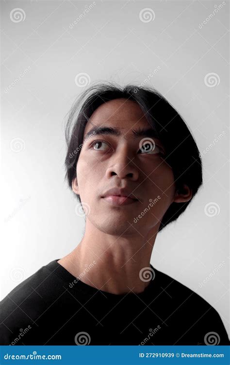 Dramatic Low Light Portrait Of Handsome Asian Man Looking Up Stock