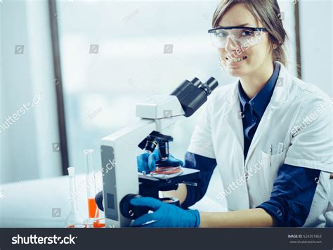 Young Scientist Looking Through Microscope Laboratory Stock Photo