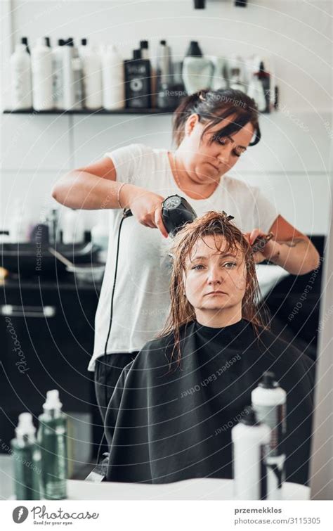 Hairdresser Styling Womans Hair A Royalty Free Stock Photo From Photocase