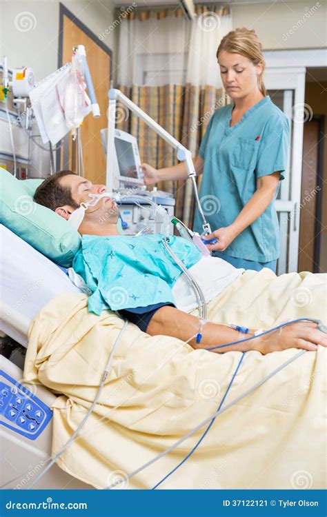 Nurse Examining Patient Lying On Bed Stock Image Image Of Holding
