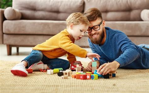 Happy Dad And Kid Playing With Toys At Home Stock Photo Image Of