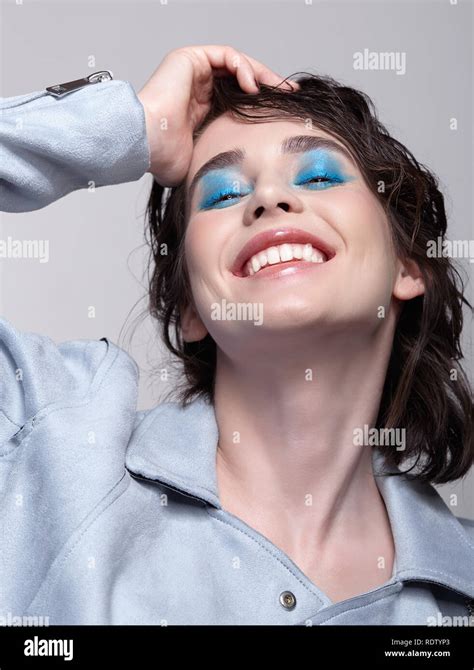 Portrait Of Smiling Female In Blue Jacket Woman With Unusual Beauty