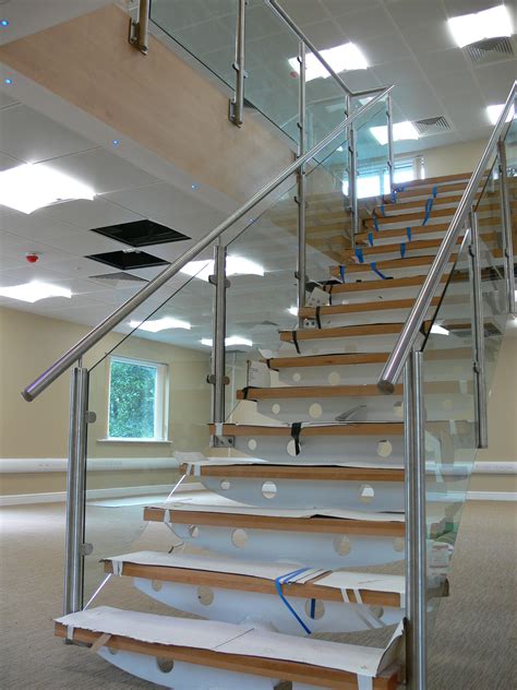 A Steel Staircase With Stainless Steel Handrails And Pan Treads Filled