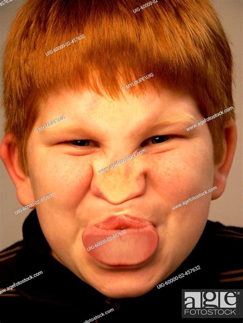 Young Boy Makes Funny Face Against Glass Stock Photo Picture And