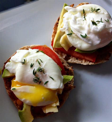 Poached Eggs With Thyme Over English Muffins With Avocado Tomato And