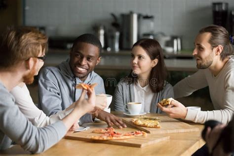 Diverse Friends Eat Pizza Enjoying Interesting Talk At Table Stock Image Image Of Friends