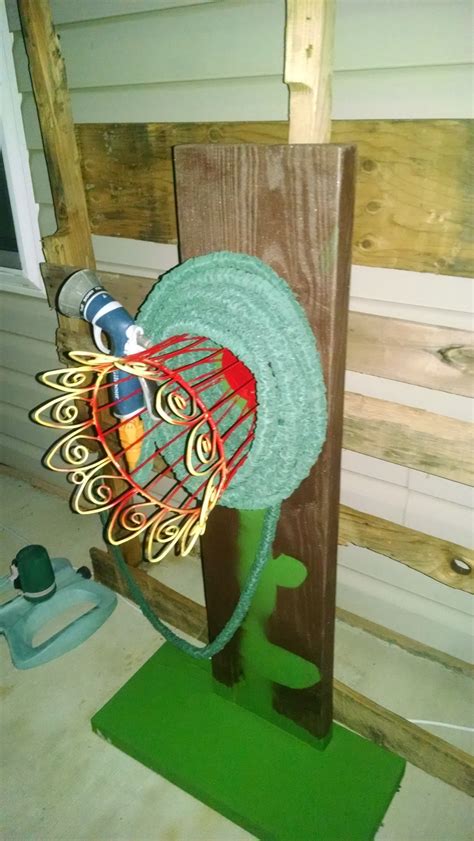 You can hang the wheel on your fence. Build Your Own Garden Hose Hanger | Goodwill Industries of ...