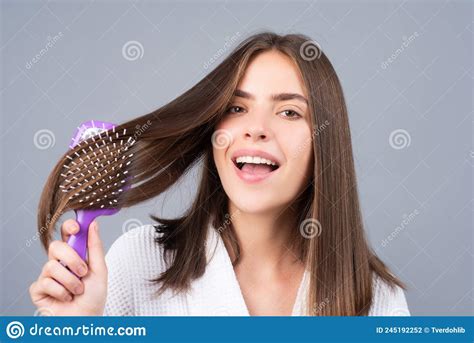 Amazed Woman Combing Hair Close Up Portrait Of Female Model With A