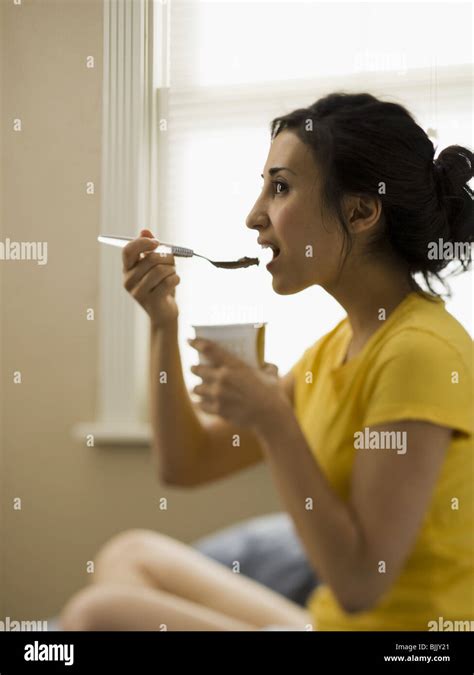 Woman Sitting And Eating Ice Cream Stock Photo Alamy