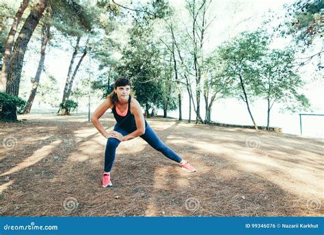 Young Fitness Woman Runner Stretching Legs Before Run Stock Photo