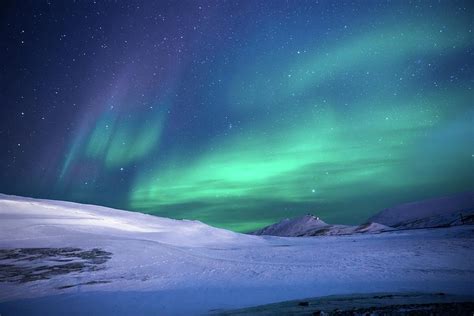 Aurora Borealis Over Snowy Mountain Landscape Photograph by GRAAL ...