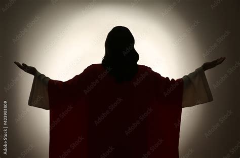 Silhouette Of Jesus Christ With Outstretched Arms On Color Background