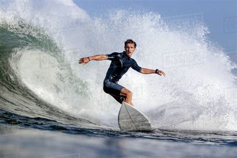 Low Angle View Of Man Surfing On Sea Stock Photo Dissolve