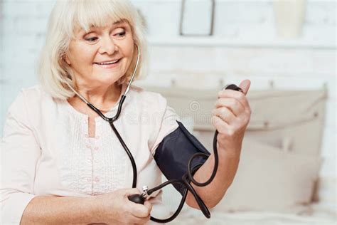 Aged Smiling Woman Measuring Blood Pressure Stock Image Image Of