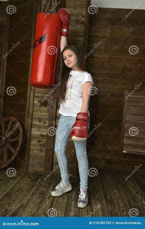 girl in boxing gloves with a punching bag stock image image of person active 216785793