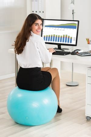 Sitting for too long without moving can lead to health problems. Should I be Sitting on an Exercise Ball at Work?