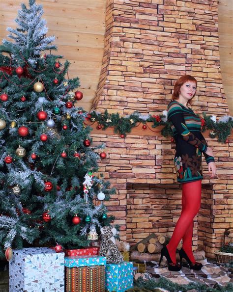 Beautiful Long Legged Redhead Girl In Red Stockings And Heels Posing In