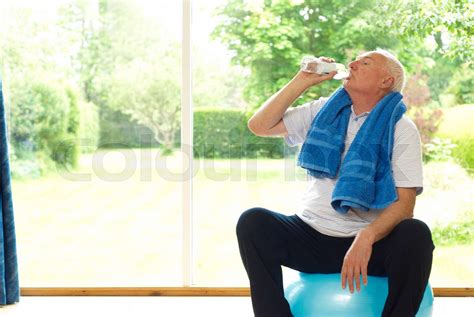 Older Man Drinking Water During Exercise Stock Image Colourbox