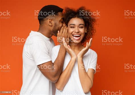 Black Man Sharing Secret With His Girlfriend Stock Photo Download