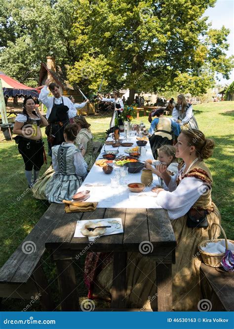 People In Medieval Costumes At Picnic Table Editorial Stock Photo