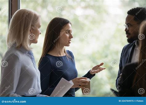 Serious Young Employee Talking To Diverse Coworkers Stock Image Image