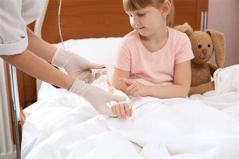 Doctor Adjusting Intravenous Drip For Little Child Stock Photo Image