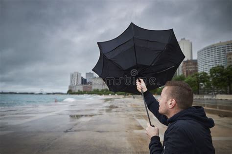 Man Holding Broken Umbrella In Strong Wind Stock Photo Image Of