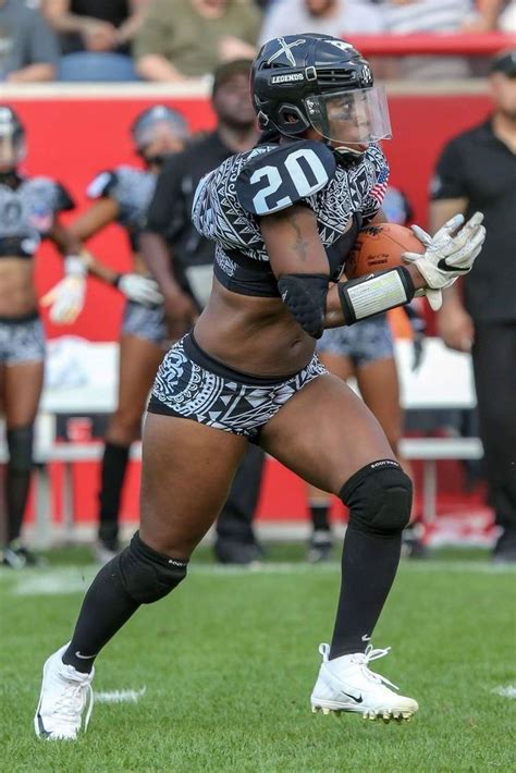 A Female Football Player Is Running With The Ball